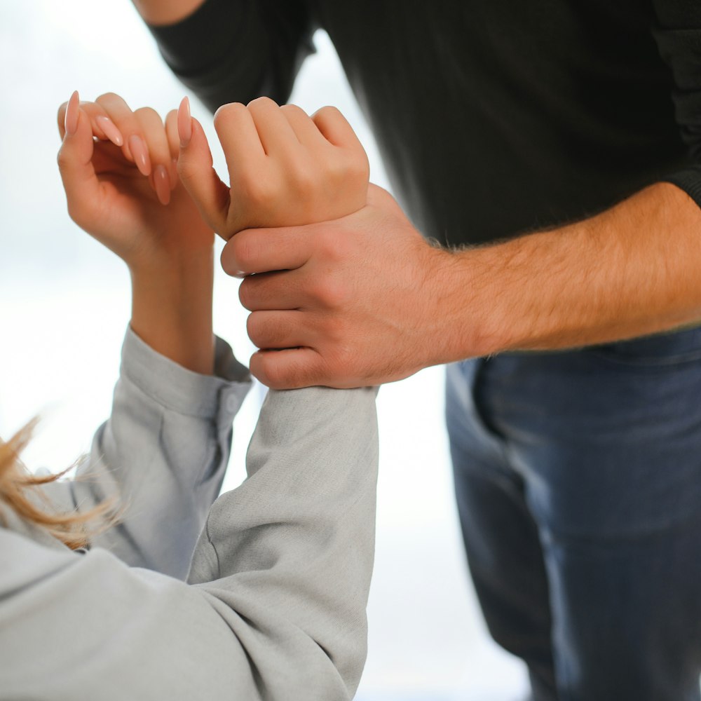 Man grabbing woman's arm