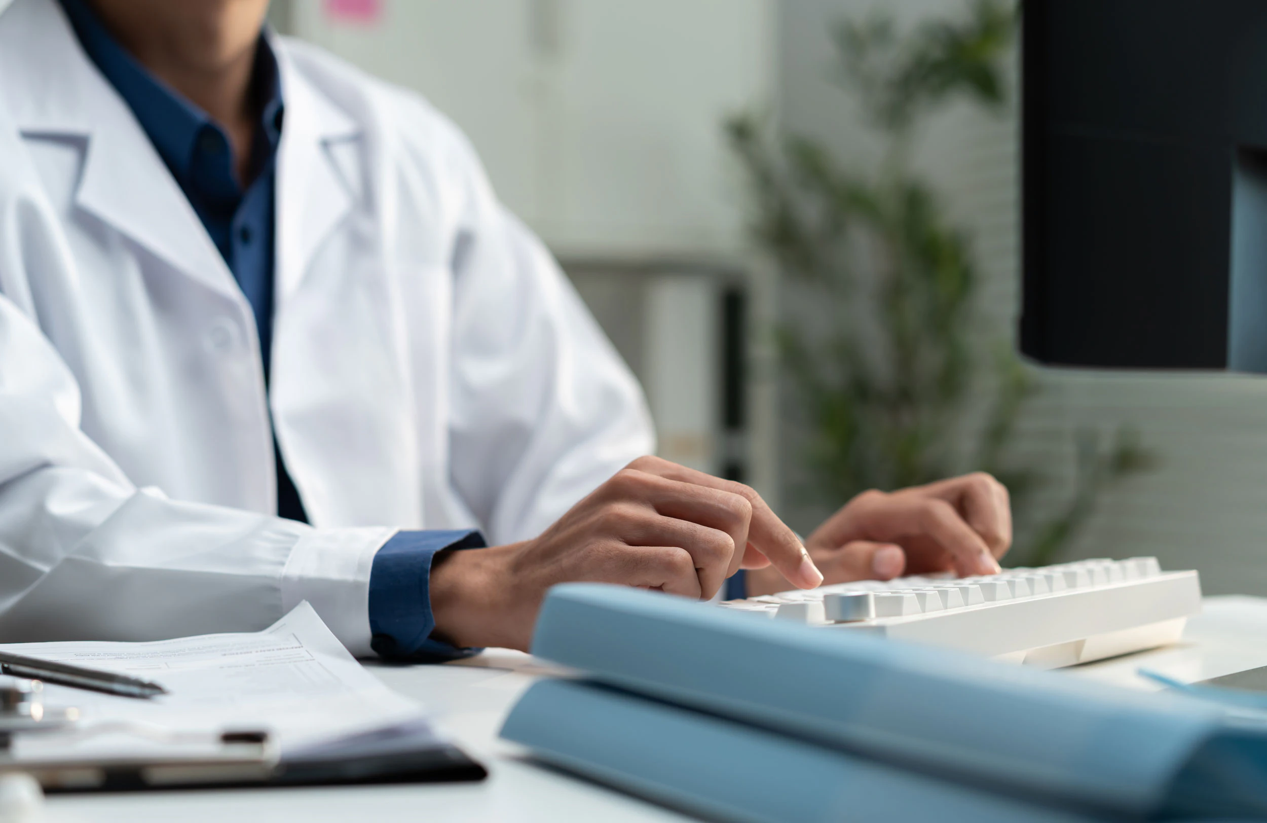 doctor typing notes