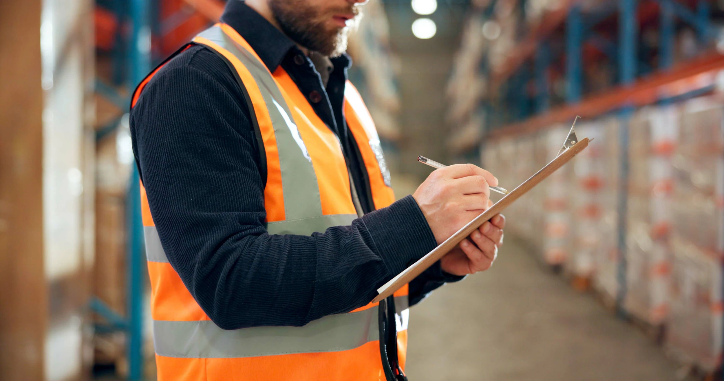 worker making notes on clipboard