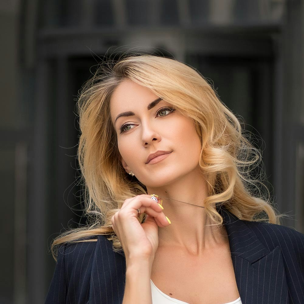 Model playing with necklace after customized injectables