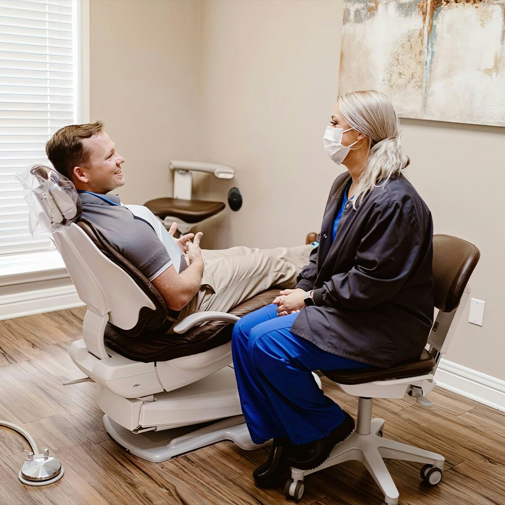 Member of dental team chatting with a patient