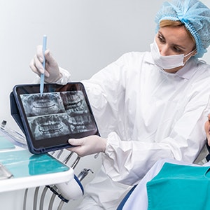 Dentist showing patient their dental x-rays