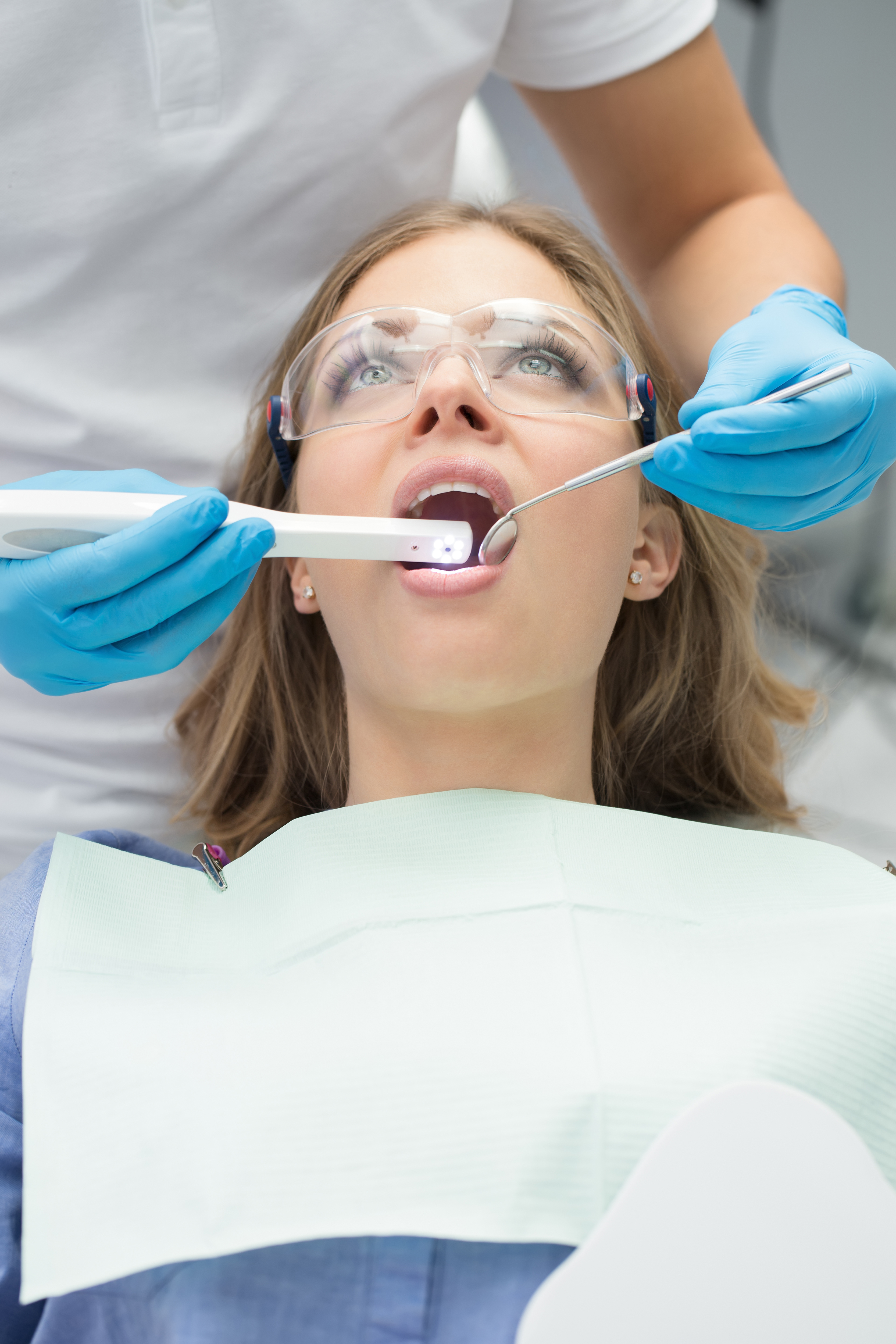 woman undergoing dental treatment with an intraoral camera