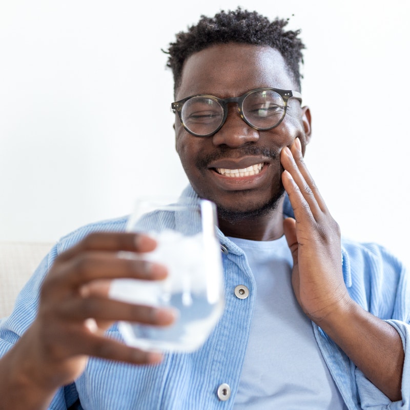 Man with toothache and ice water