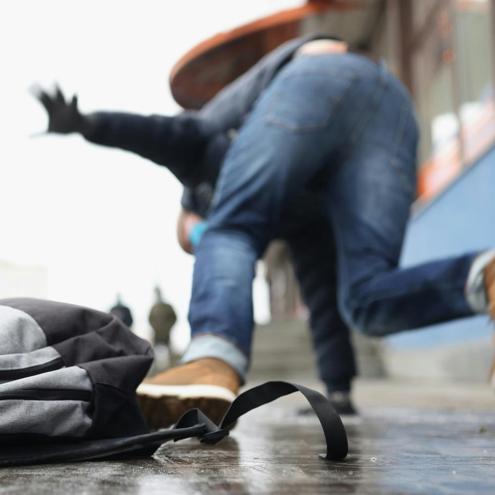 Blurred image of person wearing blue jeans falling outside