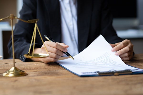 Man in suit filling out paperwork