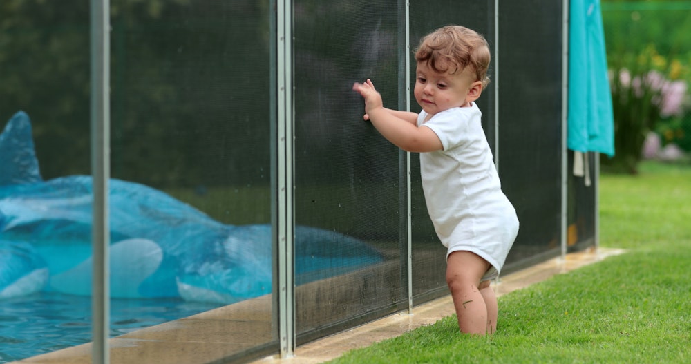 toddler blocked by pool fence