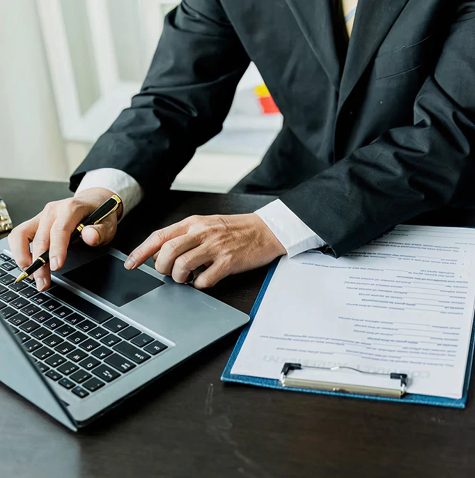 Man using laptop with a form