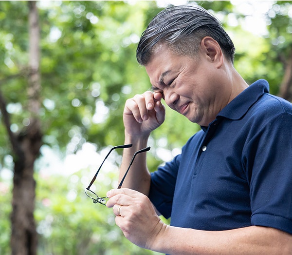 Glaucoma patient rubbing eye