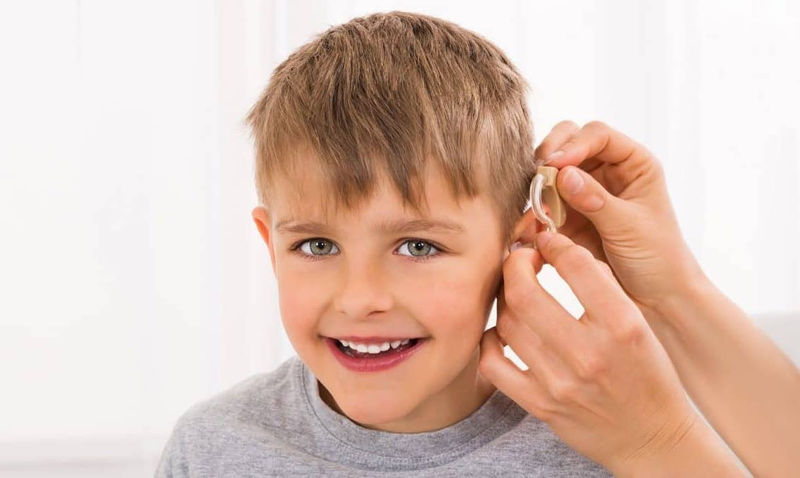 A patient with microtia getting a hearing aid.