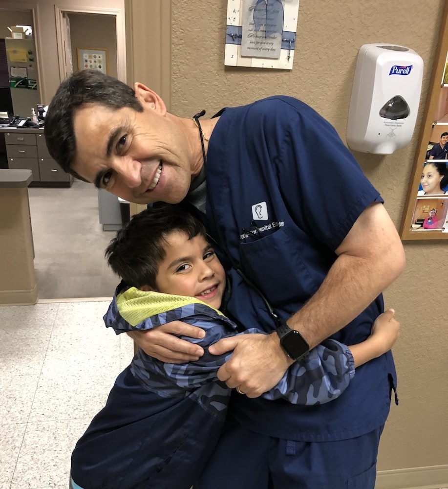 Microtia patient hugging Dr. Arturo Bonilla