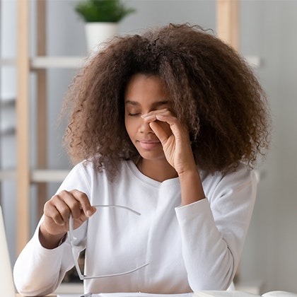 Woman rubbing eye