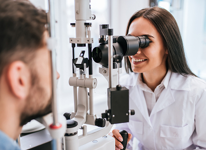 Smiling woman has eye exam