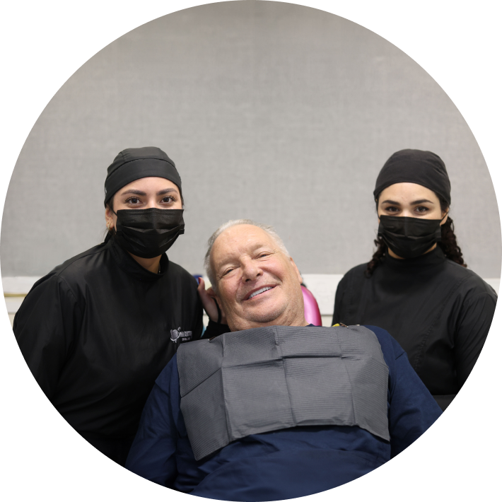 Our team smiling with a patient after their care