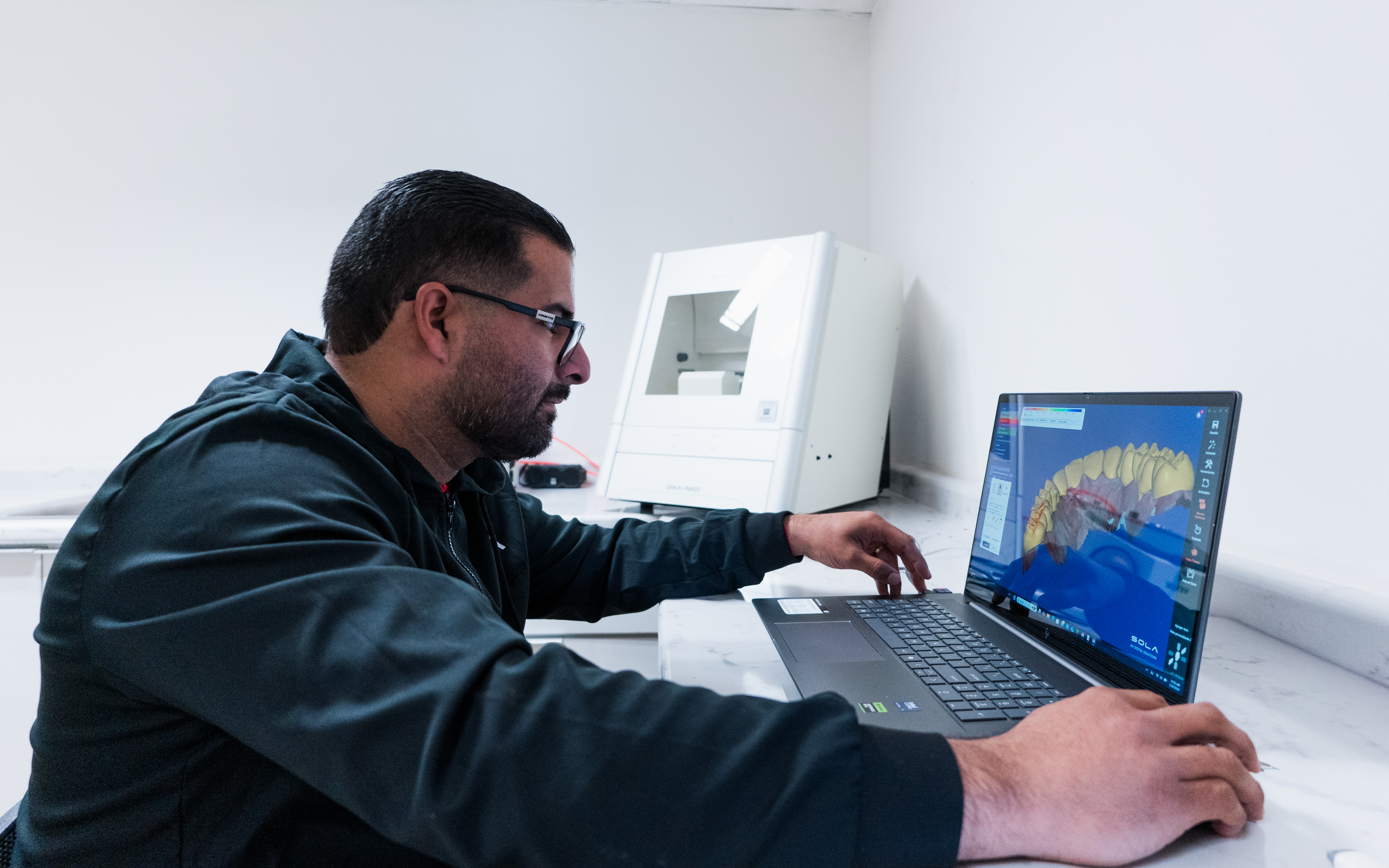 Staff member looking at a digital dental scan