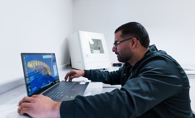 Staff member looking at a digital dental scan