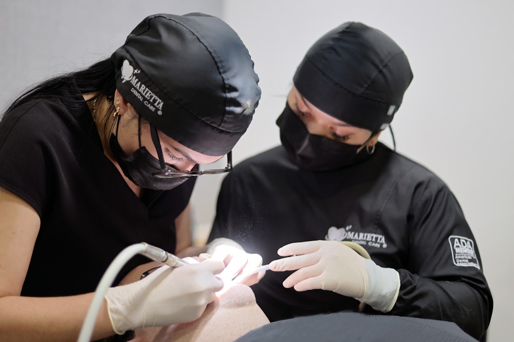 Our dentists working on a patient