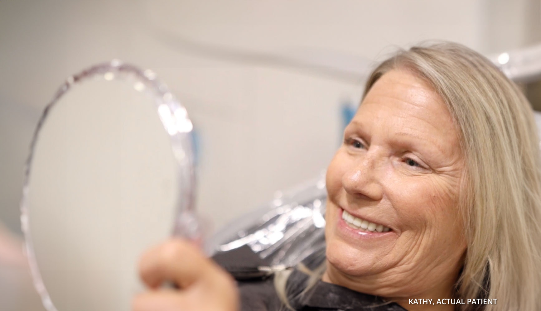 Kathy smiling in a mirror