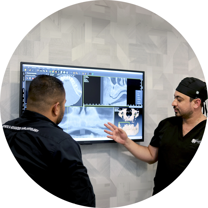 Staff showing patient a dental scan