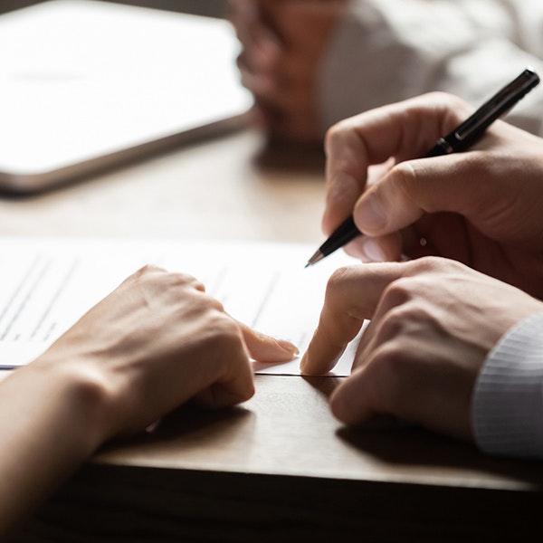 couple signing divorce papers