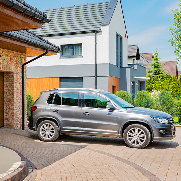 nice car in driveway of home