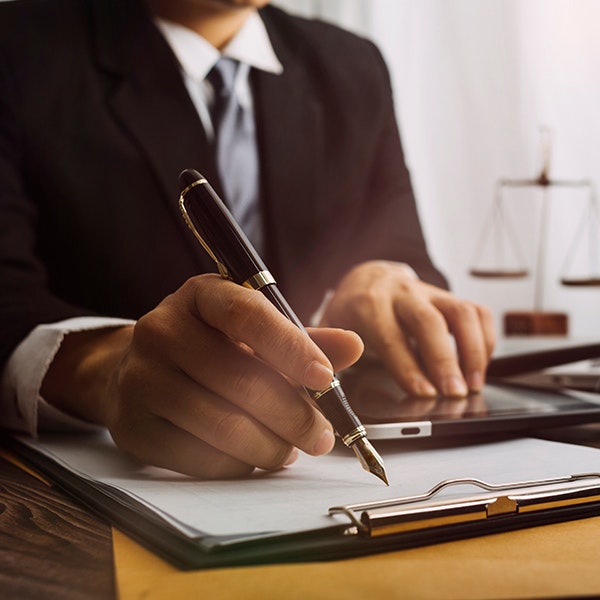 man signing paperwork