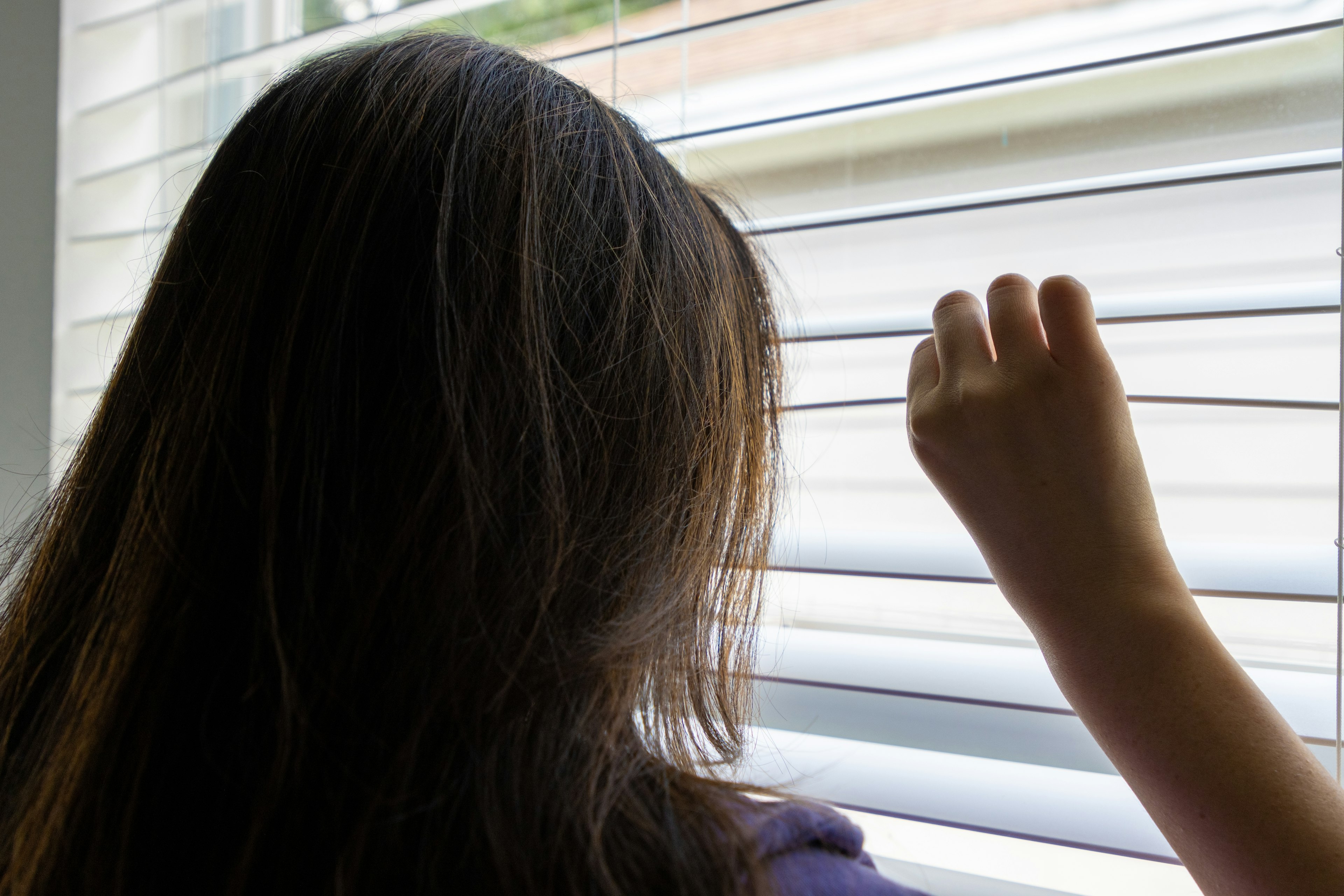 woman looking out window