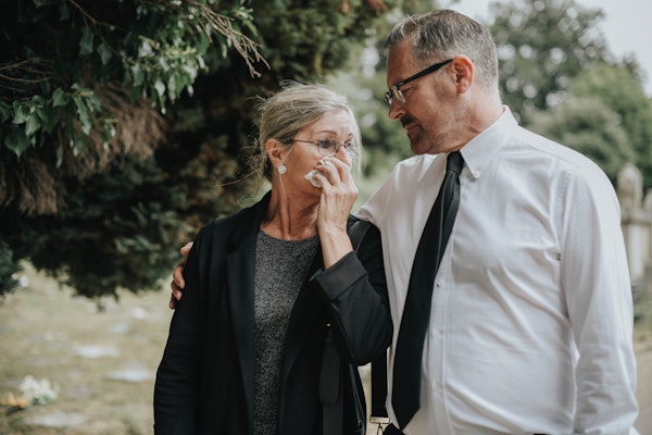 Grieving couple at cemetery