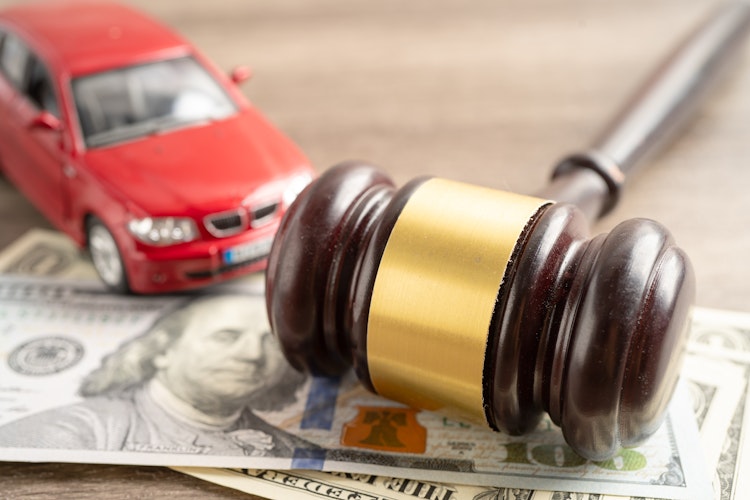 Photo of a gavel, money, and car