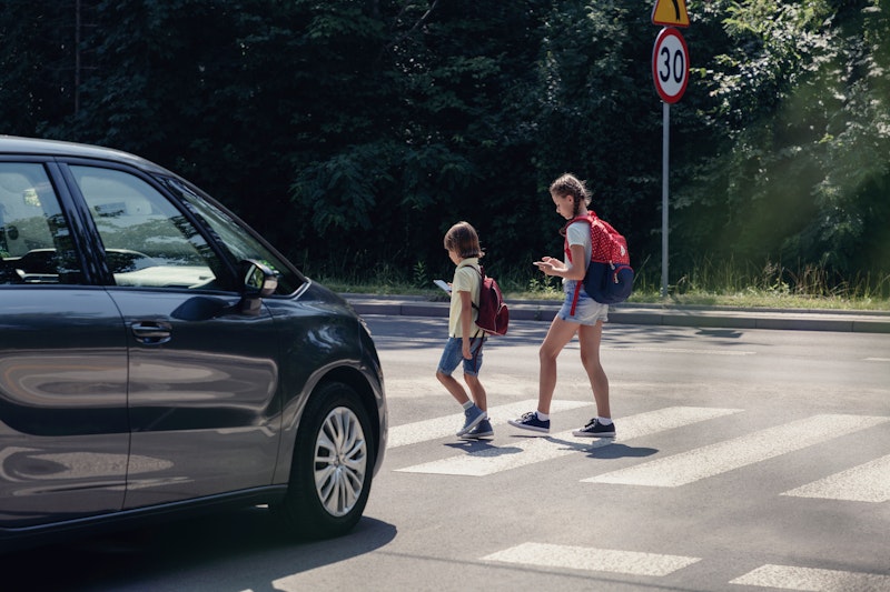 two kids crossing a street in the Greater Washington area