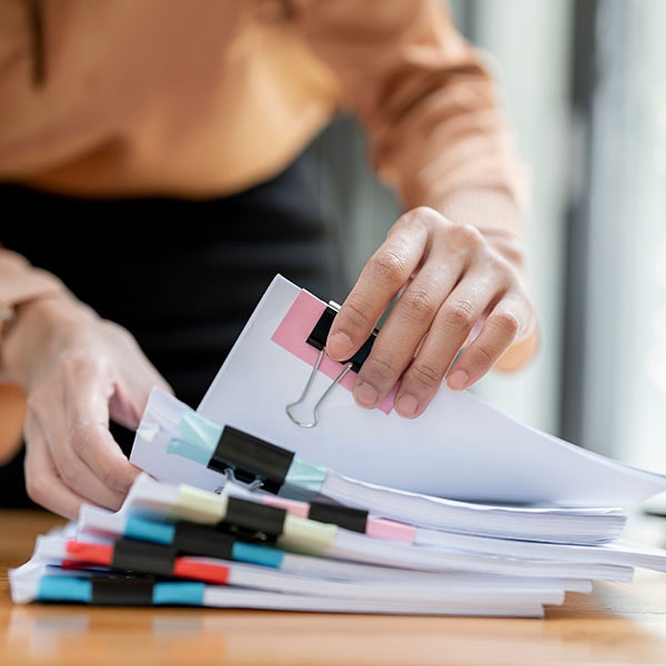 Person searching through color-coded documents related to personal injury case
