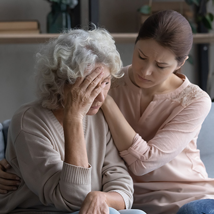 woman comforting elderly loved one