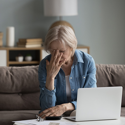mature woman stressed at computer