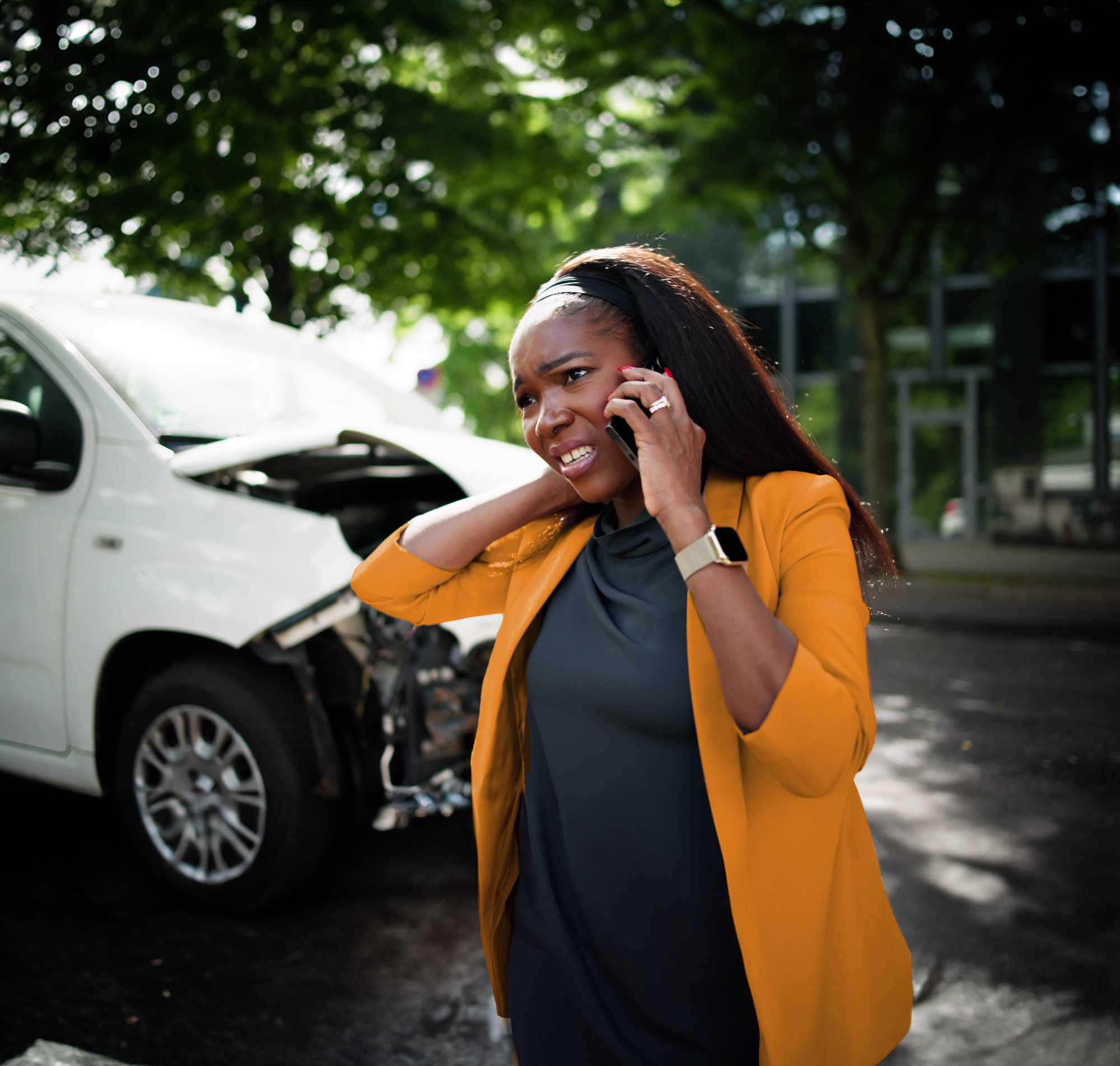 woman rubbing her neck after a car accident