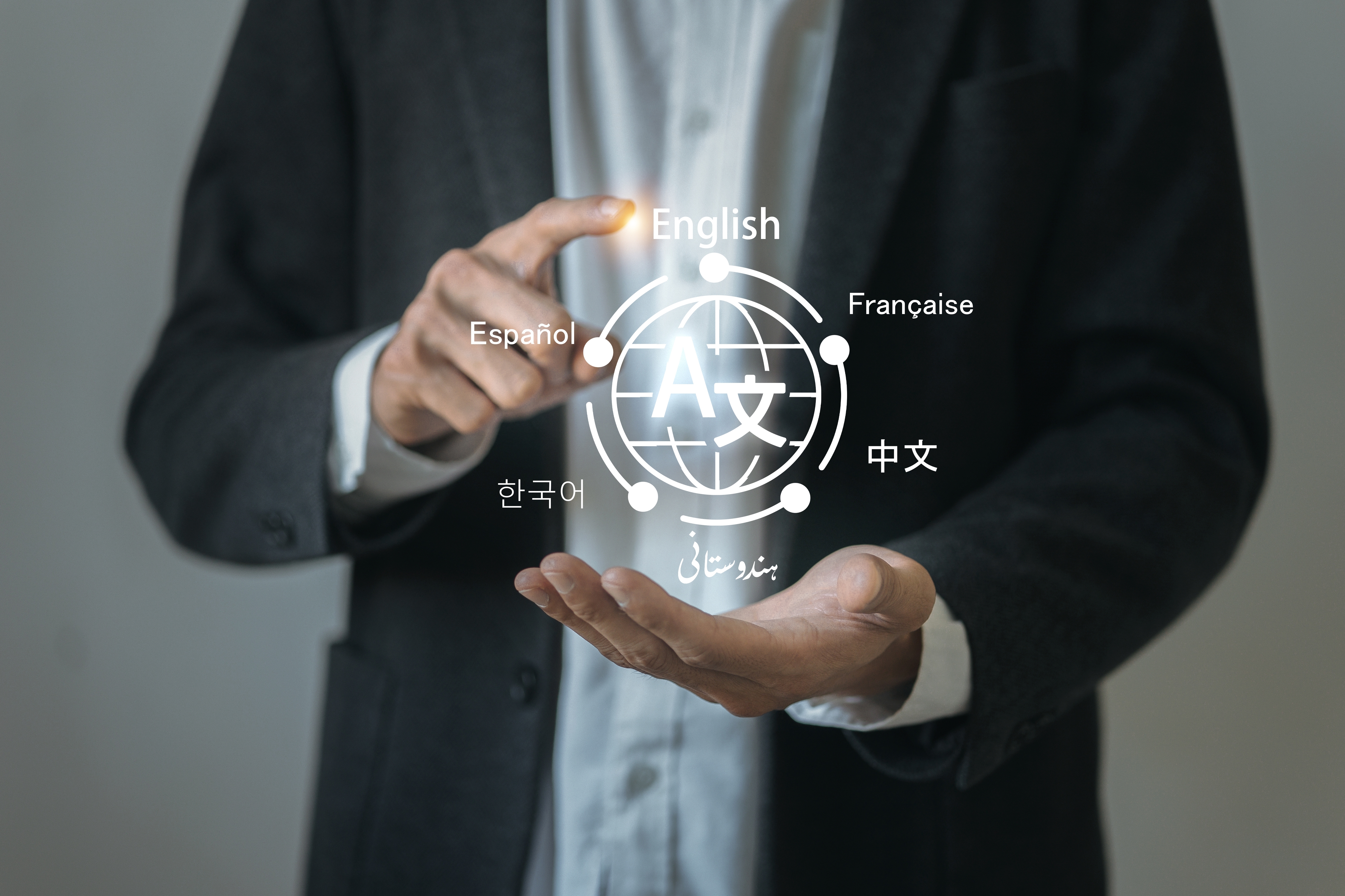 man in a blazer holding with an illustration of multiple languages appearing between his hands