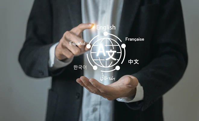 man in a blazer holding with an illustration of multiple languages appearing between his hands