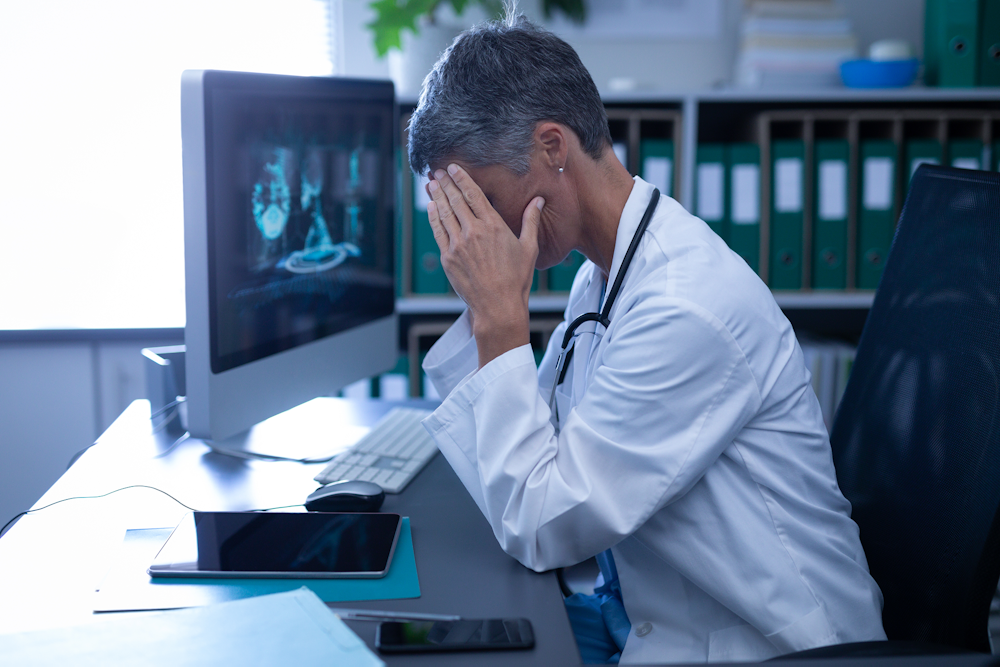 Upset doctor looking at scans