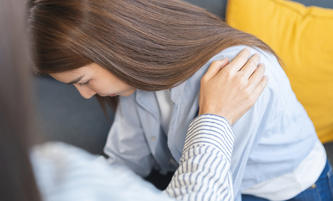 Woman in distress being comforted by a therapist
