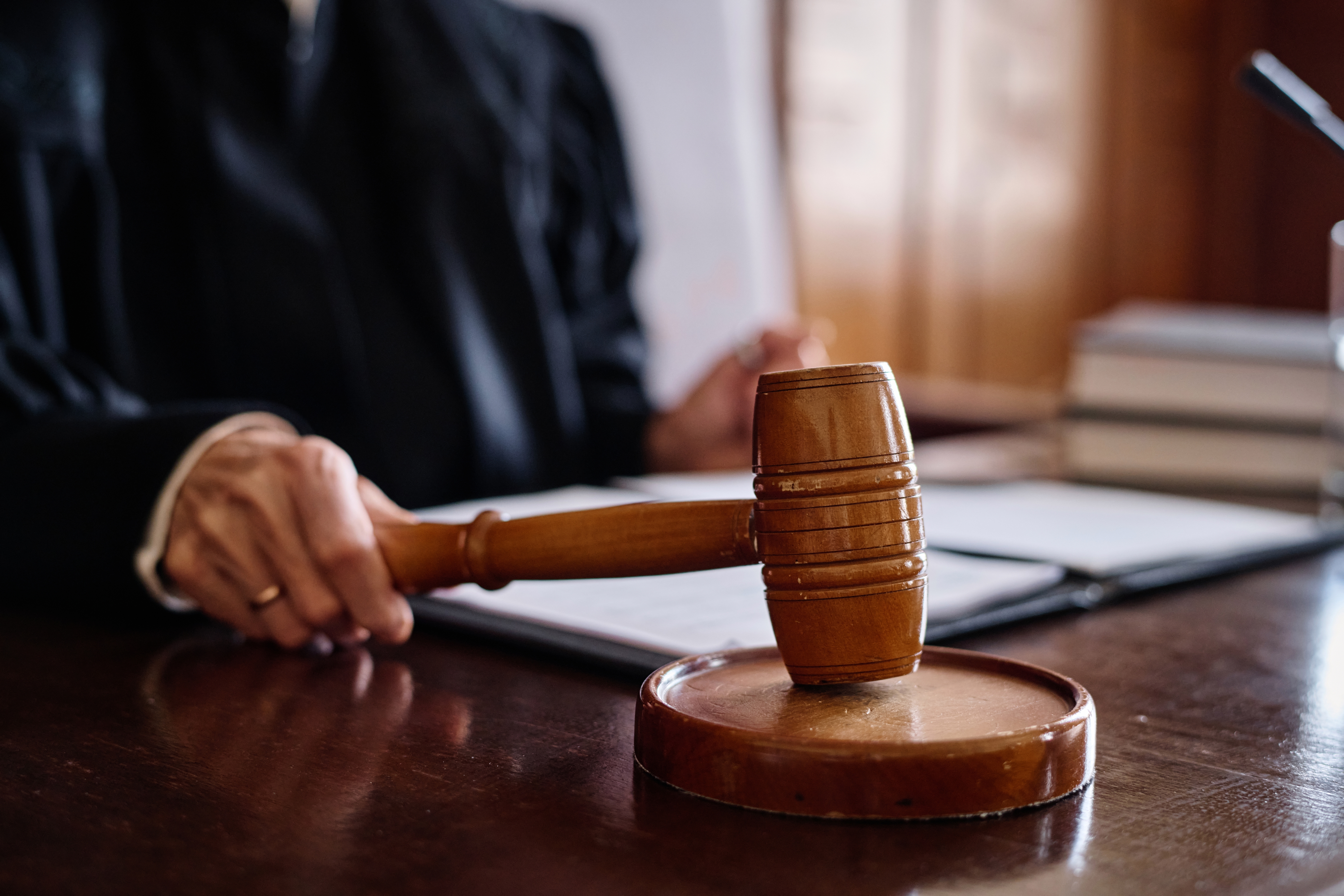 Close-up of judge hitting gavel