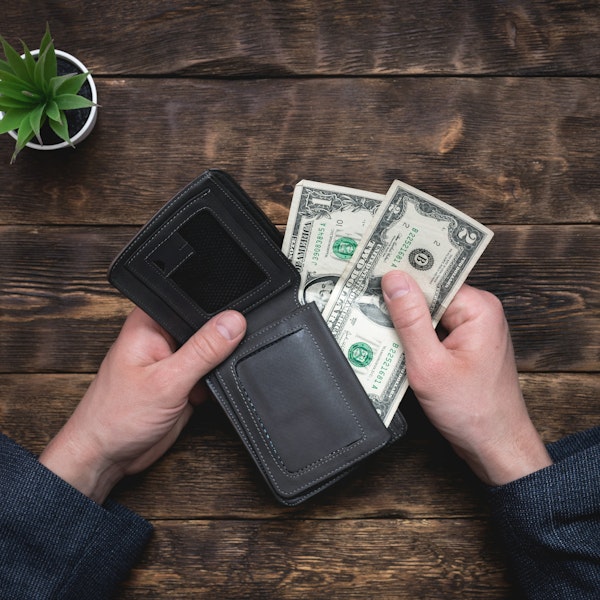 Close-up of a wallet with two one dollar bills