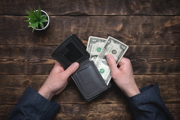 Close-up of a wallet with two one dollar bills