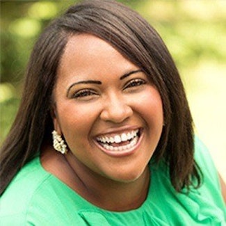 woman in green smiling