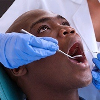 man getting oral cancer screening