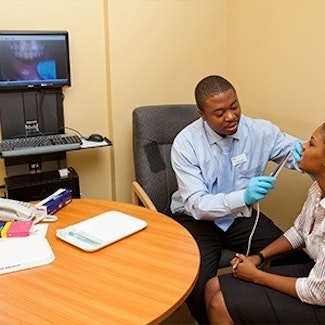 dentist using intraoral camera