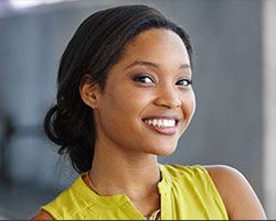 woman in yellow shirt smiling
