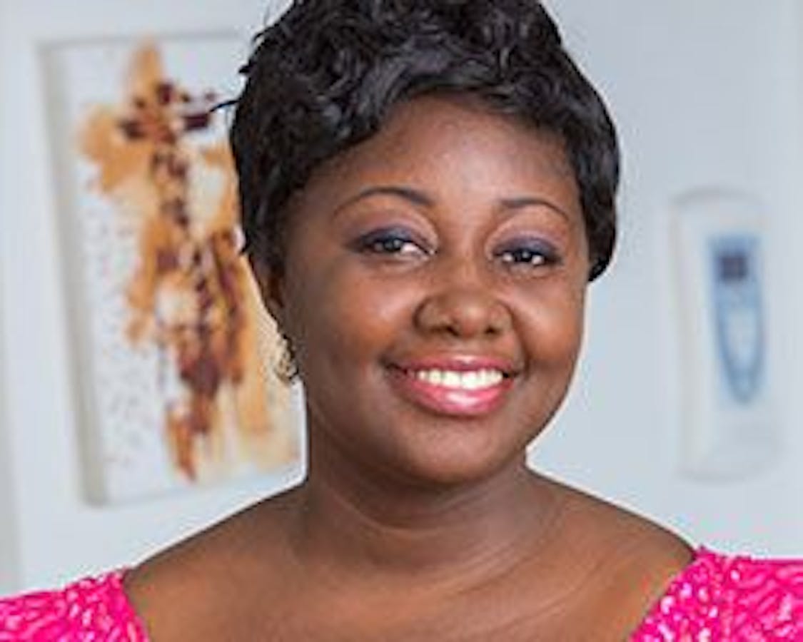 woman in bright pink shirt smiling