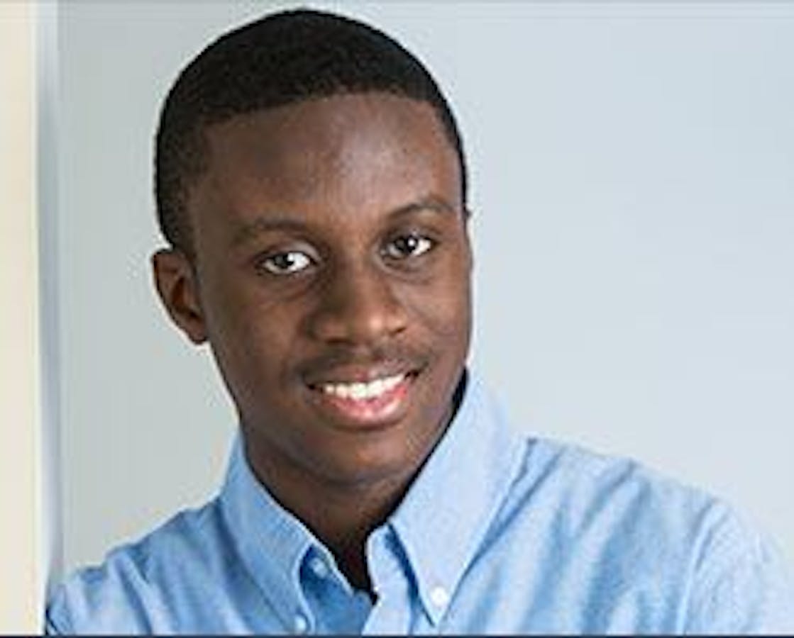 man in blue dress shirt smiling