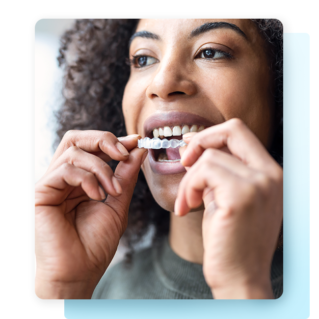 Woman putting in clear aligner tray