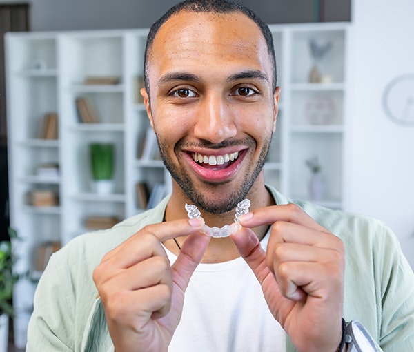 man putting in Invisalign aligner