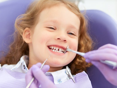 Girl receiving dental cleaning